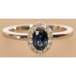 An 18ct white gold sapphire and diamond cluster ri