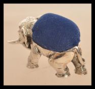 A sterling silver pincushion in the form of an ele