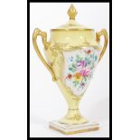 A 19th century French hand painted porcelain lidded urn vase with gilt decoration, attributed to