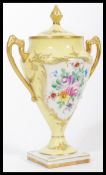 A 19th century French hand painted porcelain lidded urn vase with gilt decoration, attributed to