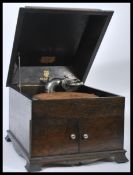 An early 20th Century Edwardian Academy oak cased table top gramophone, sarcophagus hinged lid