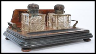 A 19th century Victorian standish having a pair of cut glass inkwells with gadrooned copper lids.