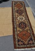 A collection of two floor rugs to include a Persian Islamic style runner measuring 290cm x 66cm,