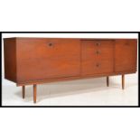 A vintage retro 20th century teak sideboard having a central bank of three drawers flanked by