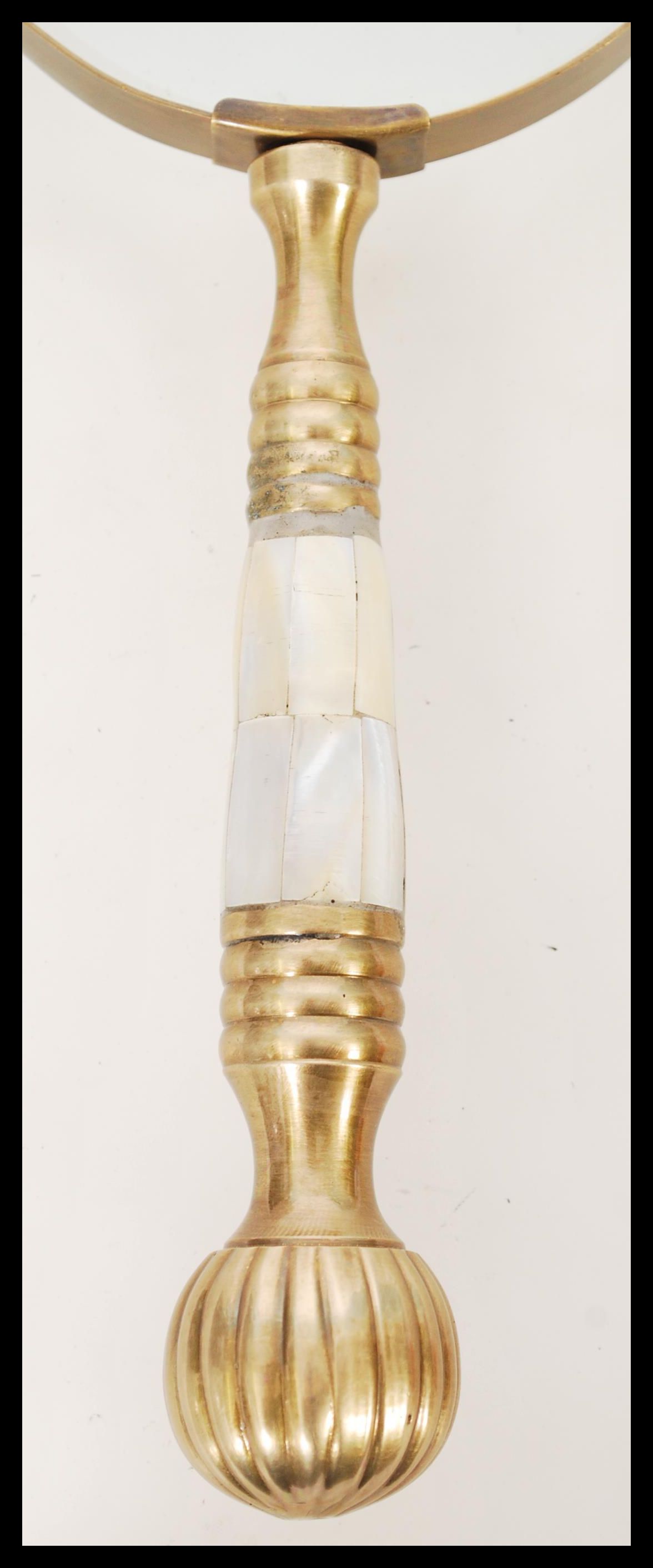 A 20th century hand held magnifying glass having a brass handle with inset mother of pearl panels. - Image 2 of 4