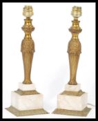 A pair of early 20th century brass and alabaster table lamps having reeded columns raised on