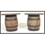 A pair of vintage early 20th Century oak coopered barrels of usual construction having a later