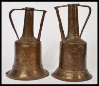 Two 19th century / early 20th century copper twin handled Dallah jugs having shaped handles and