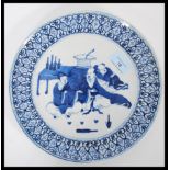 A 19th century Chinese blue and white dinner plate having hand painted decoration of three seated