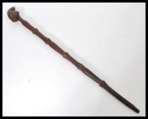 A vintage early 20th century African tribal carved hardwood walking stick cane. The handle formed as