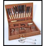 A vintage 20th Century oak cased silver plated canteen of cutlery, six person cover near complete (