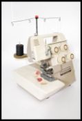 A 20th century vintage retro Bernette 334 sewing machine complete with accessories. Please see