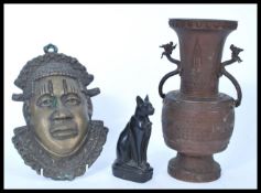 A twin handled bronzed Chinese vase together with a heavy cast mask of an African and an Egyptian