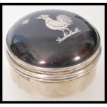 A silver hallmarked and tortoiseshell lidded trinket pot having an inlaid cockerel to lid.