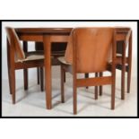 A vintage retro 20th century Elliotts of Newbury extending dining table and chairs.The table of