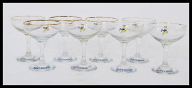 A set of eight vintage retro 20th century Babycham glasses raised on circular bases with cylindrical