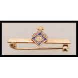 A gents vintage 9ct gold / 375 marked enamel brooch having latin inscribed crest with notation