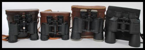 A collection of four cased binoculars to include three leather cases, dating from the 20th Century