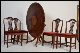 An early 20th century Edwardian plum mahogany and marquetry inlaid  tilt top circular dining table