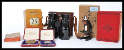 A collection of vintage items to include a cased pair of binoculars, a WWI Active Service