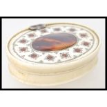 A 18th century Ivory and Tortoiseshell snuff box of oval form with central tortoiseshell cartouche