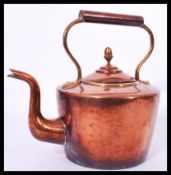 A 19th century large Victorian copper teapot with acorn finial lid along with a similar aged brass