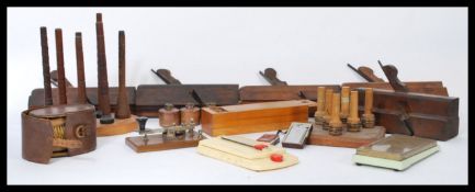 A collection of vintage items to include cotton bobbins on stand, wood planes, inkwells etc.