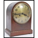 An Edwardian mahogany spire cased mantel clock with silvered dial and an inset 8 day brass