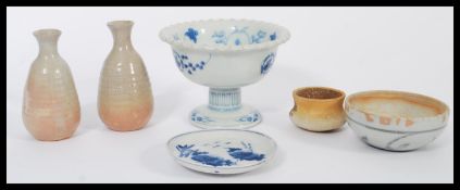 A group of Japanese ceramics and stoneware to include a blue and white footed tazza or cup, pair