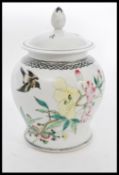 A Chinese Republic period porcelain jar and cover having hand enamelled decoration with