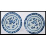 A pair of 19th century Chinese blue and white hand painted plates decorated with floral sprays and