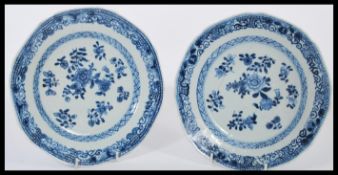 A pair of 19th century Chinese blue and white hand painted plates decorated with floral sprays and