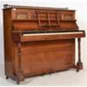 A Victorian Arts & Crafts mahogany and brass upright cottage piano by Fred Oetzmann of London. The