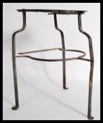An 18th century Georgian fretwork brass and steel trivet stand raised on shaped tripod stand.