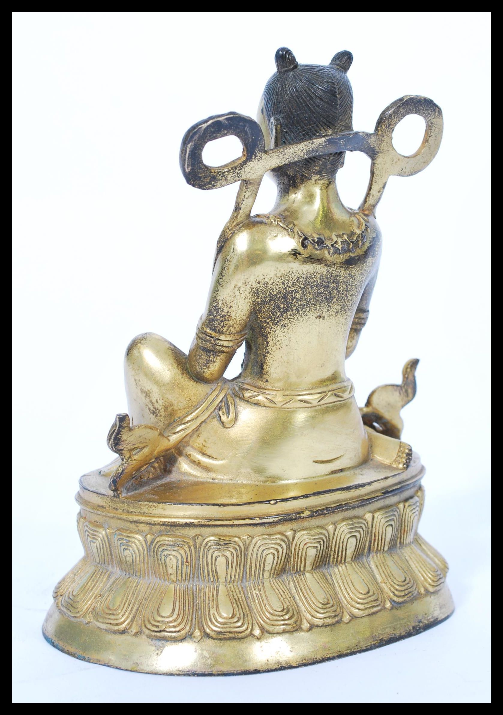 A 19th century gilt bronze statue of a Buddha raised on pedestal base with scrolled robe and - Image 2 of 4