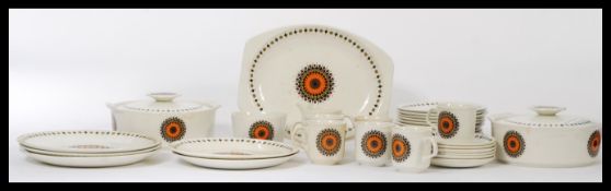 A vintage retro 20th century J&G Meakin studio pottery dinner service having a vibrant retro print