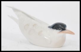 A Royal Copenhagen ceramic figurine of a Tern stamped to the base 827 entitled Arctic Tern. Makers