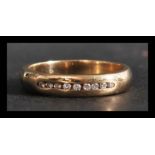 A hallmarked 9ct gold and diamond band ring having