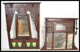 A Victorian mahogany and tile hanging coat stand rack with central mirror and green tiles surrounded