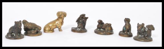 A group of bronze small paperweights depicting animals, dogs, mice etc. along with a small bronze