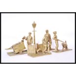 A collection of large brass cast figurines to include dustman and cart, hunter with dog, postman and