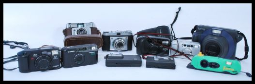 A group of vintage cameras to include Kodak Retinette, disc 6000, Minolta Riva Zoom 135ex, Yashica