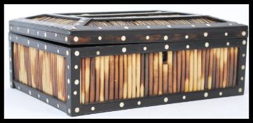 A 19th century porcupine quill worked  ebony and bone inlaid box with brass armorial escutcheon to