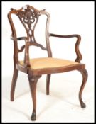 An Edwardian mahogany inlaid salon armchair. Raised on cabriole legs with drop in seat and