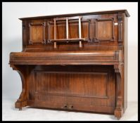 A late 19th century walnut cased upright iron bound piano by Eberhardt of Berlin. The walnut case