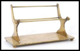 A 19th century brass telescope stand in the form of a bench raised on plinth base with ball ends.
