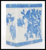 A 19th century Chinese blue and white ceramic square pillow vase hand painted with flowers and