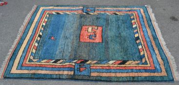 A 20th century thick pile alpaca woolen rug with a blue ground. The rug features alpaca detailing in