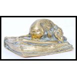 A 19th century Victorian heavy brass desk paperweight in the form of a mouse seated on an antique