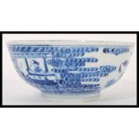 A 19th century Chinese blue and white bowl hand painted with scene of Geisha's fences and  trees